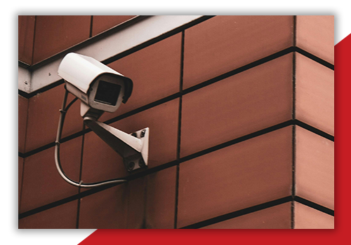 CCTV security camera installed on at the top part of a brick wall
